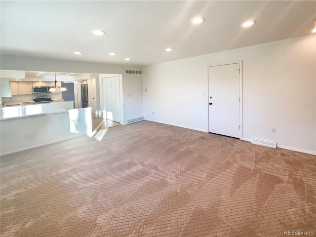 unfurnished living room featuring carpet and visible vents