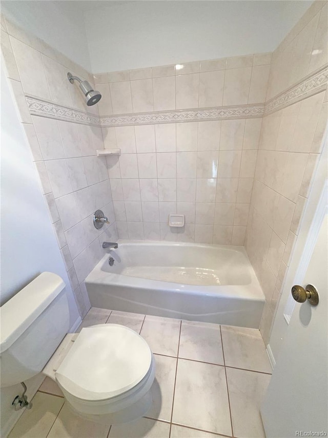 full bath with tile patterned floors, toilet, and shower / tub combination