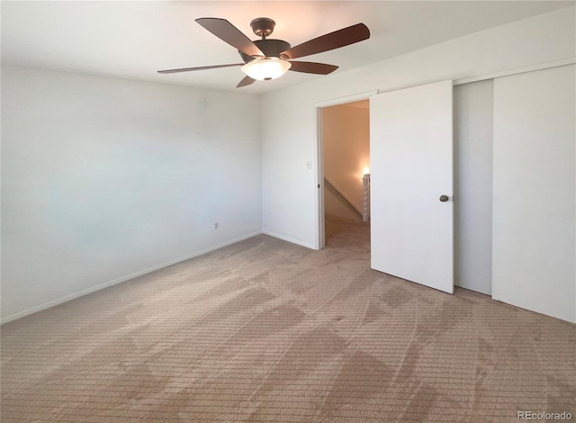 unfurnished bedroom featuring carpet flooring, a ceiling fan, and a closet