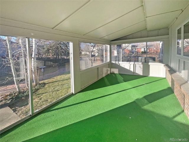 unfurnished sunroom with lofted ceiling