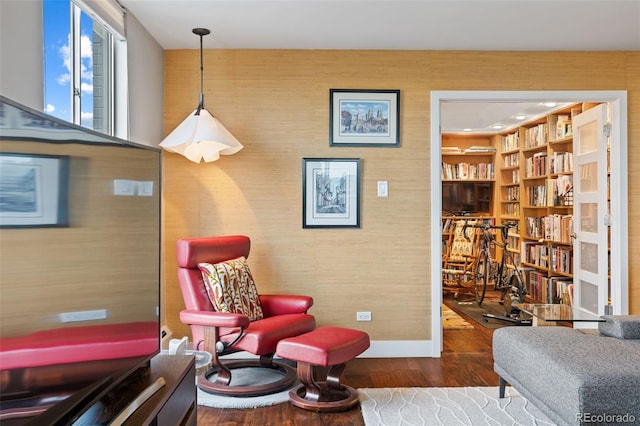 4570 E Yale Ave Unit 1104, Denver, CO 80222 - sitting room featuring wood finished floors, wallpapered walls, and baseboards