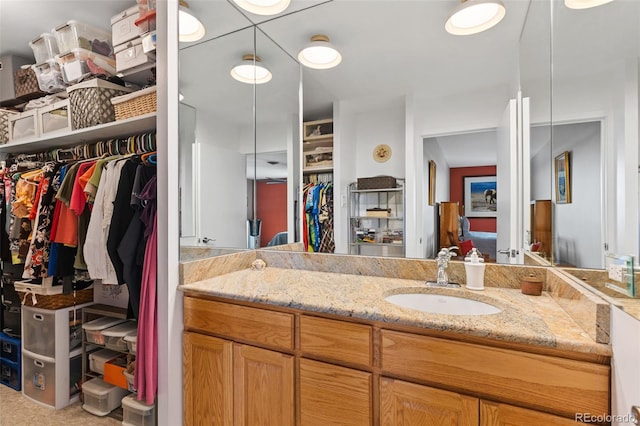 4570 E Yale Ave Unit 1104, Denver, CO 80222 - bathroom with vanity and a spacious closet