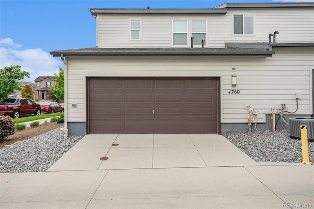 4760 Kittredge St, Denver, CO 80239 - garage with central AC and concrete driveway