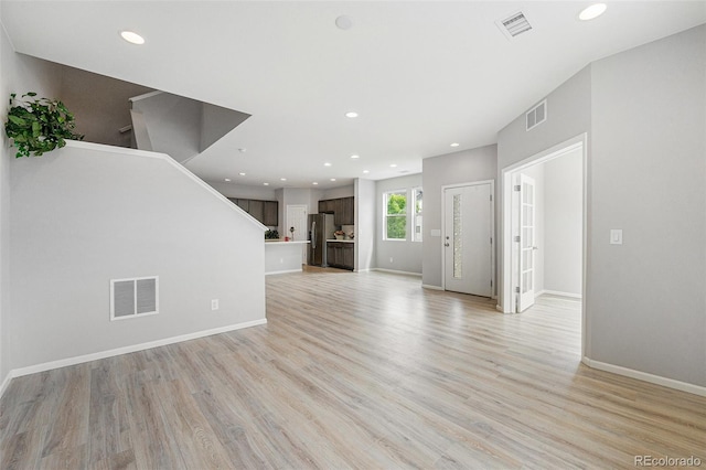 4760 Kittredge St, Denver, CO 80239 - unfurnished living room with light wood-style flooring, baseboards, recessed lighting, and stairs