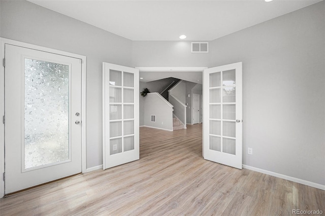 4760 Kittredge St, Denver, CO 80239 - empty room with french doors, wood finished floors, baseboards, stairway, and recessed lighting