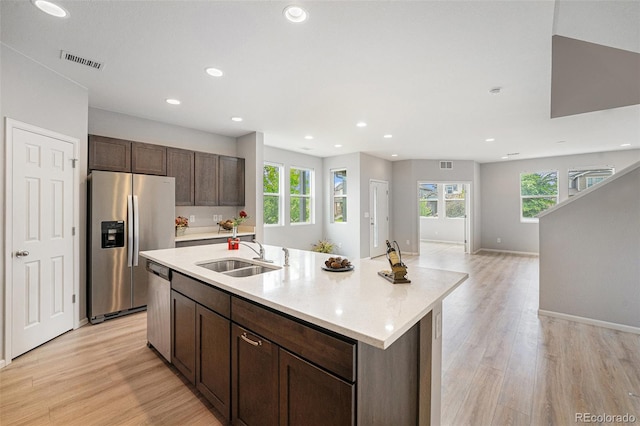 4760 Kittredge St, Denver, CO 80239 - kitchen with stainless steel appliances, a sink, plenty of natural light, light wood-type flooring, and recessed lighting