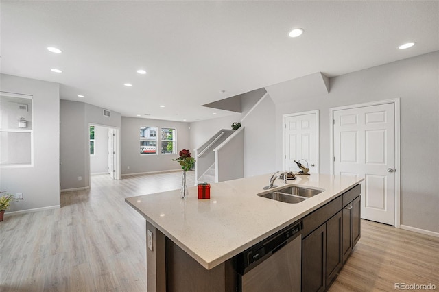 4760 Kittredge St, Denver, CO 80239 - kitchen featuring dishwasher, a sink, light wood-style floors, baseboards, and recessed lighting