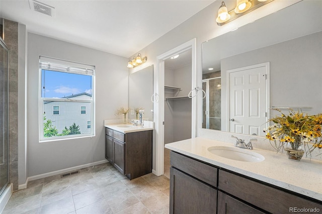 4760 Kittredge St, Denver, CO 80239 - bathroom with a stall shower, two vanities, baseboards, and tile patterned floors