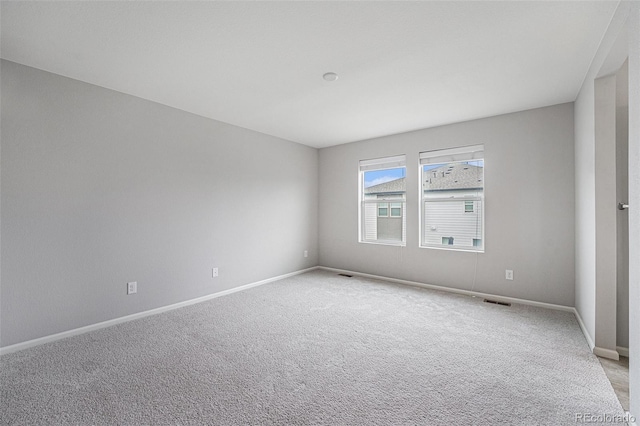 4760 Kittredge St, Denver, CO 80239 - empty room with light carpet and baseboards