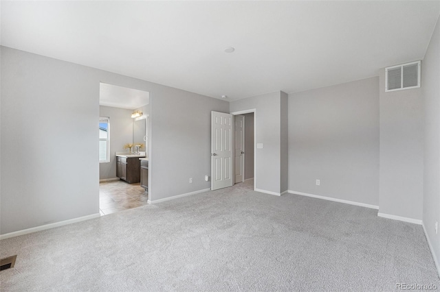 4760 Kittredge St, Denver, CO 80239 - unfurnished bedroom with light colored carpet, baseboards, and ensuite bath