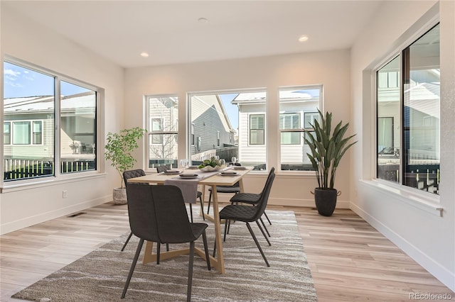 dining area featuring a healthy amount of sunlight and light hardwood / wood-style flooring