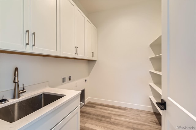 clothes washing area featuring sink, cabinets, washer hookup, electric dryer hookup, and light hardwood / wood-style floors