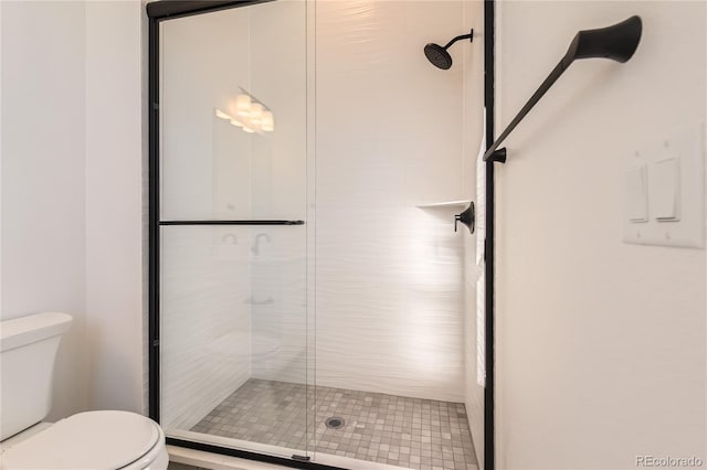 bathroom with an enclosed shower and toilet