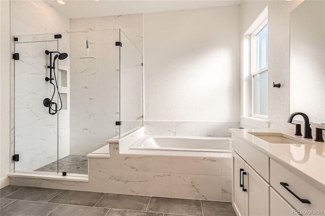 bathroom with plus walk in shower, tile patterned flooring, and vanity