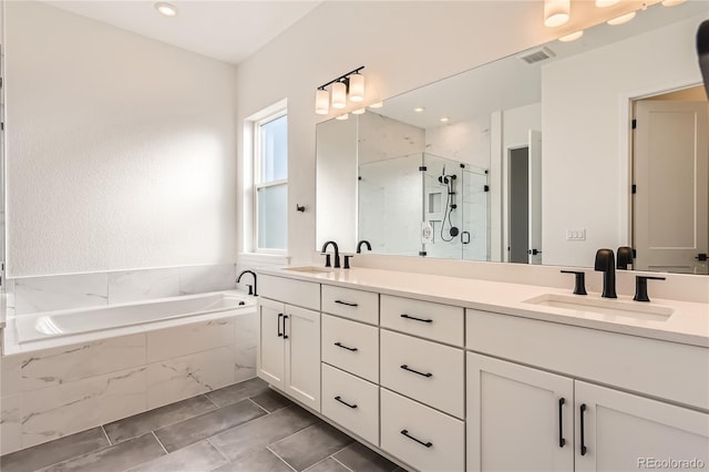 bathroom with tile patterned flooring, vanity, and separate shower and tub