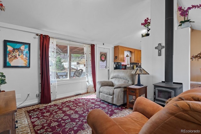 living area with a wood stove and baseboards