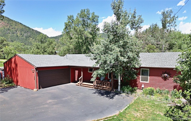96 Greeley Blvd, Palmer Lake, CO 80133 - view of front of property with an attached garage, a shingled roof, asphalt driveway, and a mountain view