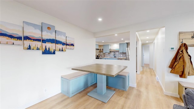 dining area featuring recessed lighting, baseboards, and light wood-style floors