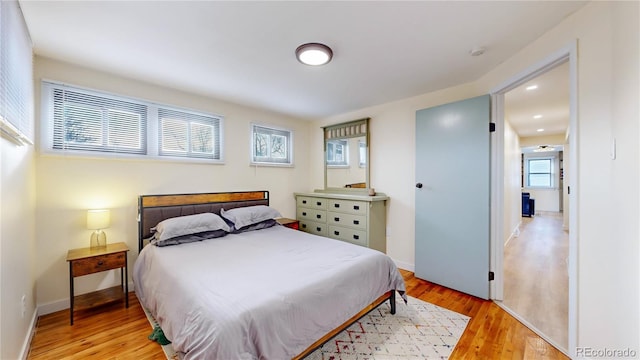 bedroom featuring recessed lighting, baseboards, and light wood-type flooring