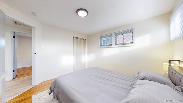 bedroom featuring baseboards and light wood-style floors