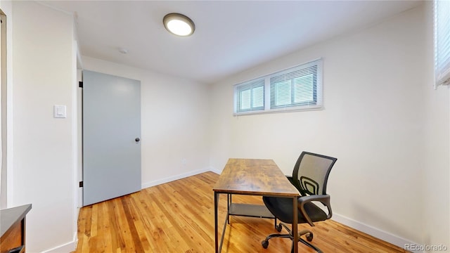 office featuring baseboards and light wood-type flooring