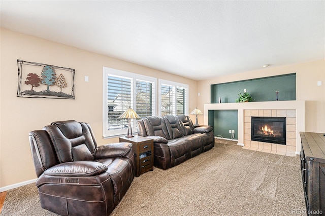 living room featuring carpet flooring, a fireplace, and baseboards