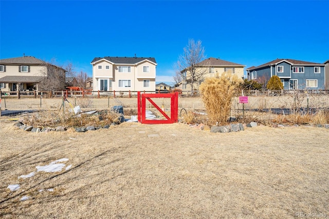 view of yard featuring fence and a residential view