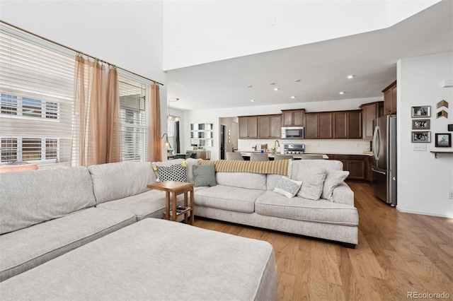 living area featuring light wood-style floors and recessed lighting