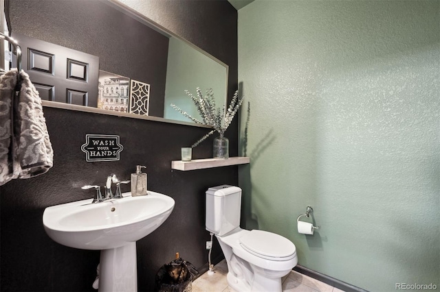 12264 Olive Way, Thornton, CO 80602 - half bath featuring a textured wall and tile patterned floors