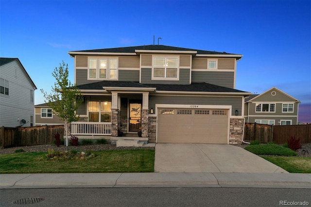 12264 Olive Way, Thornton, CO 80602 - prairie-style home with covered porch, concrete driveway, stone siding, and an attached garage