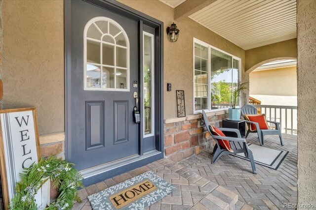 1385 Candleglow St, Castle Rock, CO 80109 - doorway to property with covered porch and stucco siding