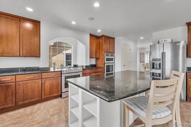 1385 Candleglow St, Castle Rock, CO 80109 - kitchen featuring stainless steel appliances, open shelves, dark stone countertops, a kitchen island, and recessed lighting