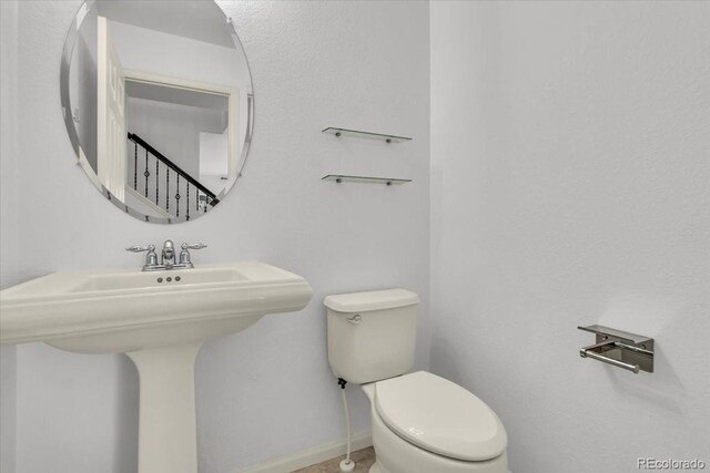 1385 Candleglow St, Castle Rock, CO 80109 - bathroom with toilet, baseboards, and a sink