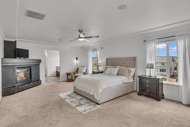 1385 Candleglow St, Castle Rock, CO 80109 - bedroom with crown molding, carpet floors, multiple windows, a glass covered fireplace, and ceiling fan