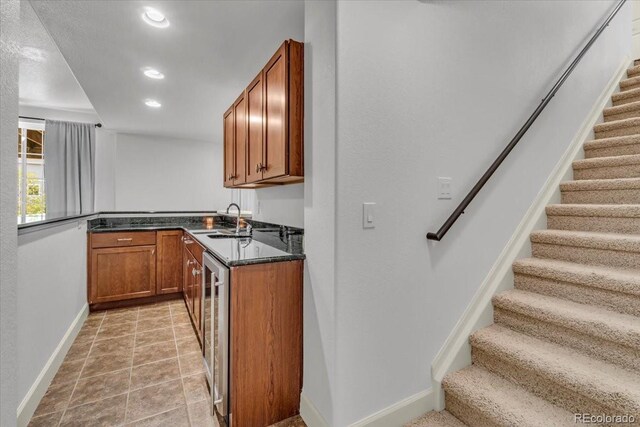 1385 Candleglow St, Castle Rock, CO 80109 - kitchen featuring a sink, baseboards, brown cabinetry, recessed lighting, and wine cooler