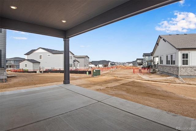 view of yard featuring a patio and a residential view