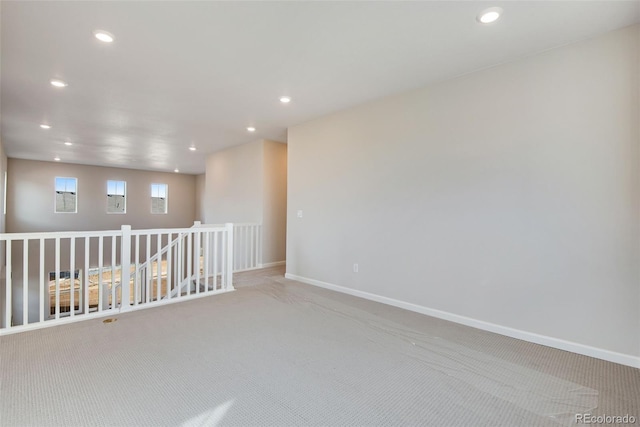 spare room with recessed lighting, carpet flooring, and baseboards