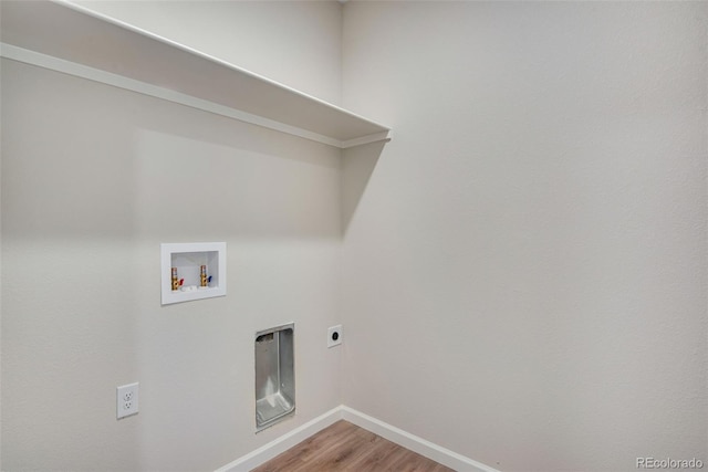 clothes washing area with hookup for a washing machine, light wood-style flooring, laundry area, baseboards, and electric dryer hookup