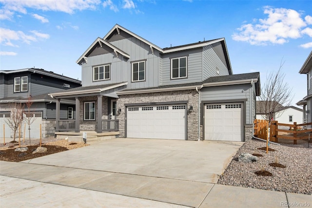 craftsman inspired home featuring covered porch, a garage, fence, driveway, and board and batten siding