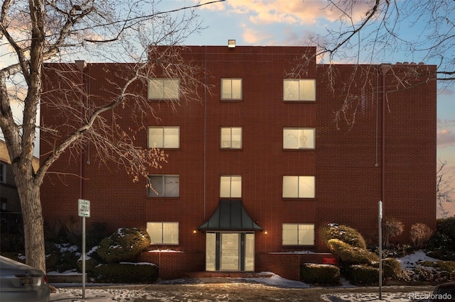 view of outdoor building at dusk