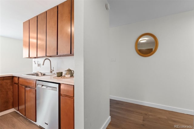 kitchen featuring dishwasher, dark hardwood / wood-style flooring, and sink