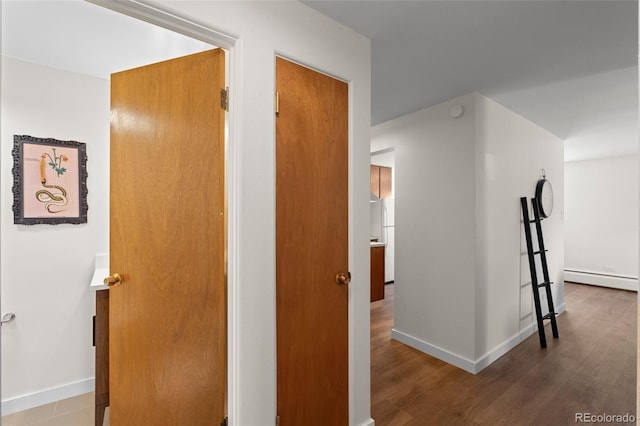 hallway featuring hardwood / wood-style flooring and a baseboard radiator