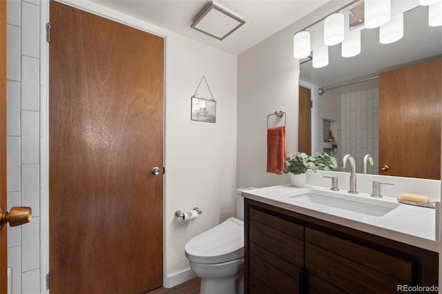 bathroom with vanity, toilet, and walk in shower