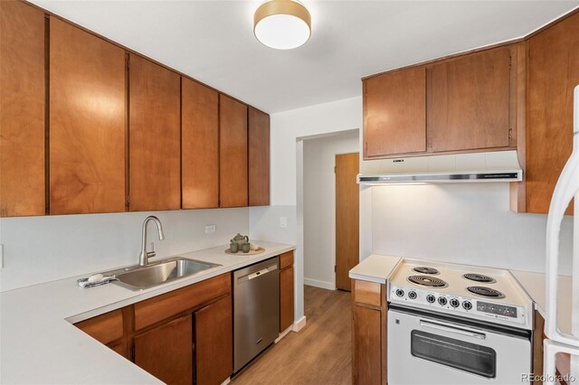 kitchen with under cabinet range hood, light countertops, white electric stove, and dishwasher