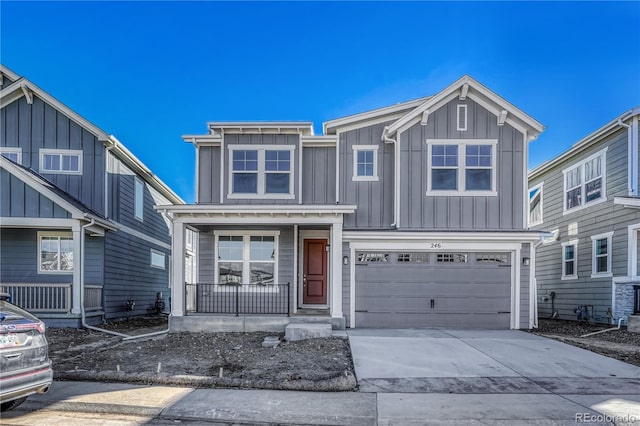 view of front of house with board and batten siding, a porch, driveway, and a garage