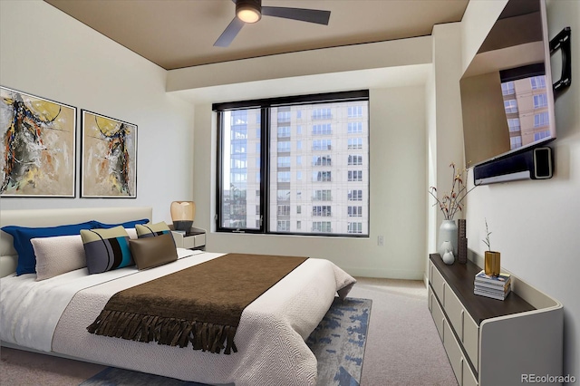 bedroom featuring ceiling fan and light carpet