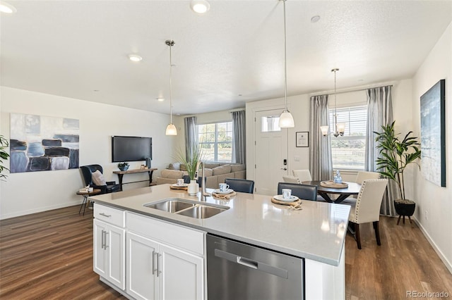 kitchen with sink, dishwasher, hardwood / wood-style flooring, and an island with sink