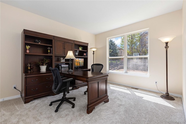 home office with light colored carpet and baseboards