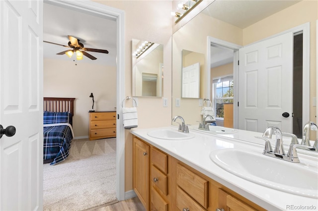 ensuite bathroom featuring double vanity and a ceiling fan