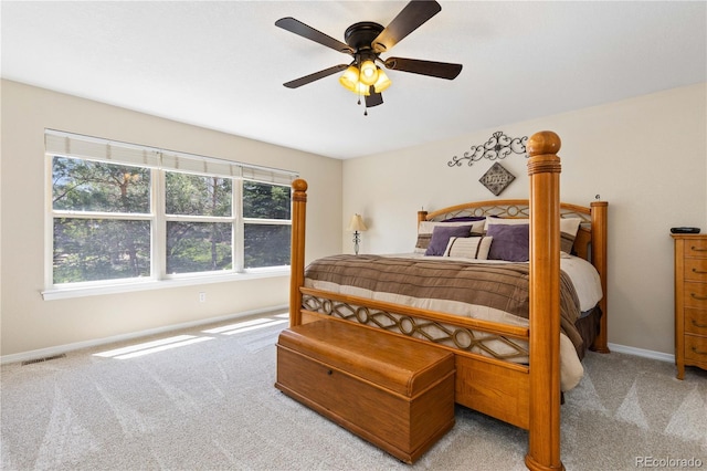 carpeted bedroom featuring baseboards and a ceiling fan